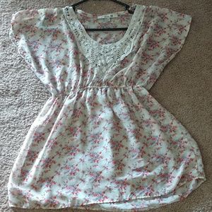 A shirt that has flowers all over it